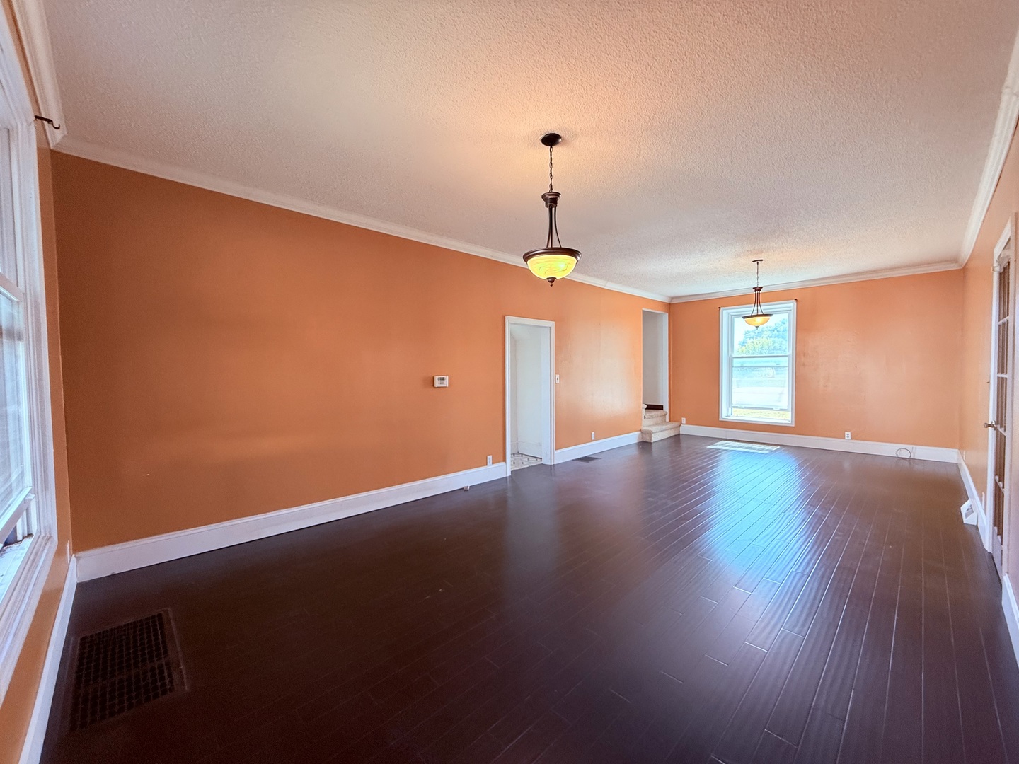 402 North Madison Street Clinton, IL 61727 - Photo 6 of 24 a view of an empty room with window and wooden floor