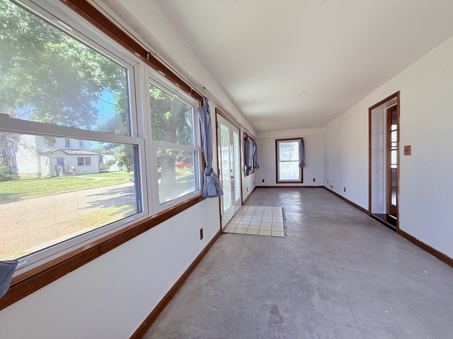 402 North Madison Street Clinton, IL 61727 - Photo 7 of 24 a view of a big room with wooden floor and windows