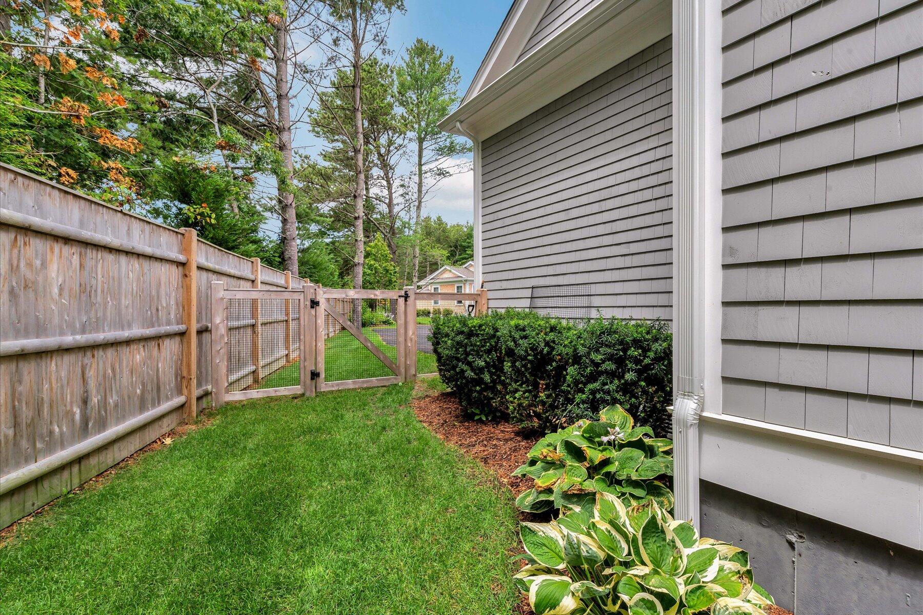 14 Willow Circle Mashpee, MA 02649 - Photo 13 of 60 a view of a backyard with potted plants and large tree