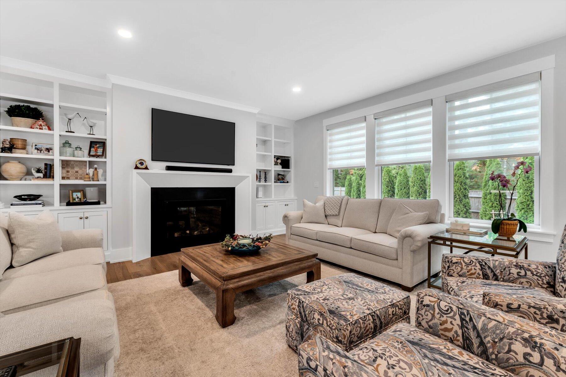 14 Willow Circle Mashpee, MA 02649 - Photo 23 of 60 a living room with furniture a flat screen tv and a fireplace