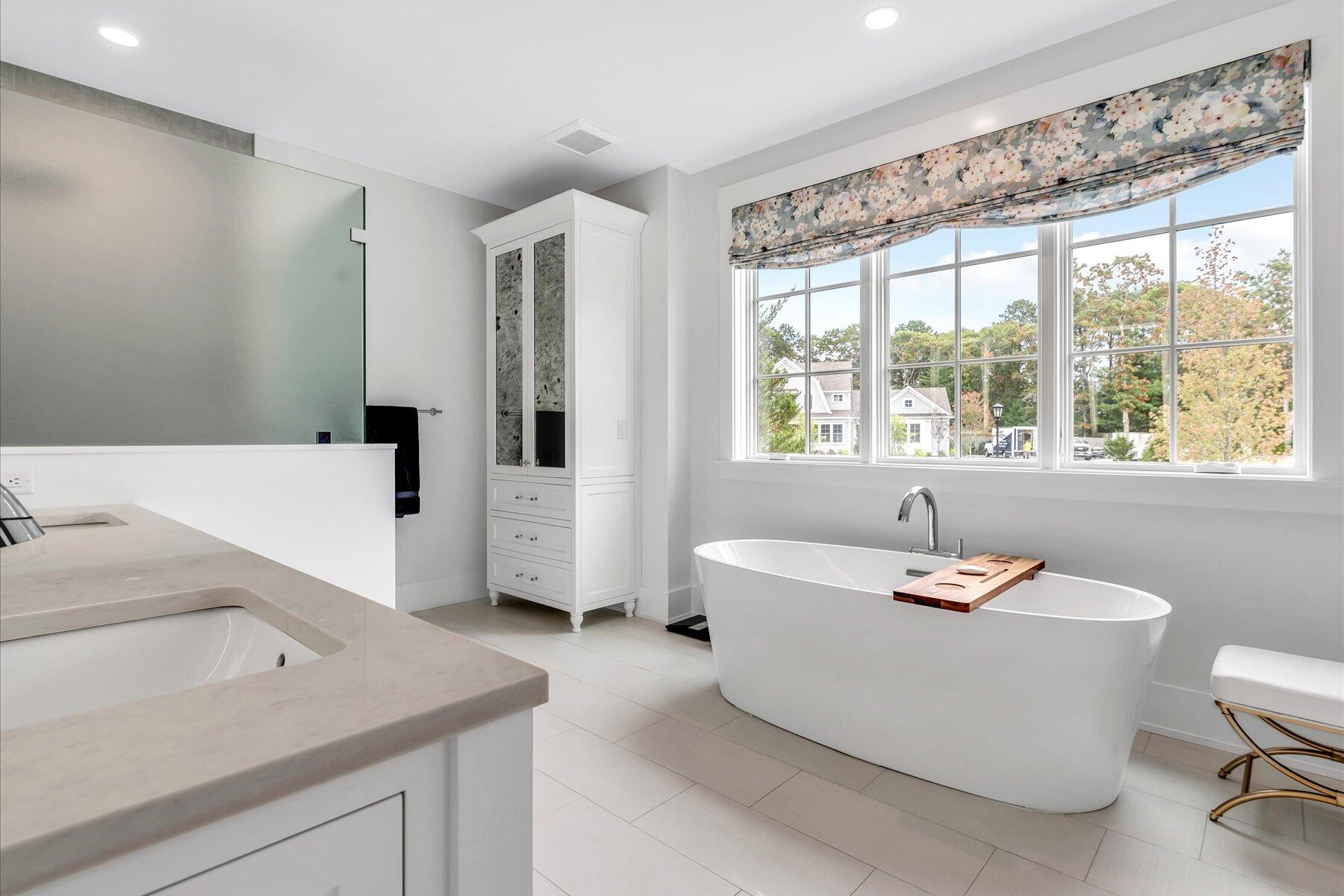 14 Willow Circle Mashpee, MA 02649 - Photo 42 of 60 a bathroom with a sink a bathtub and a window