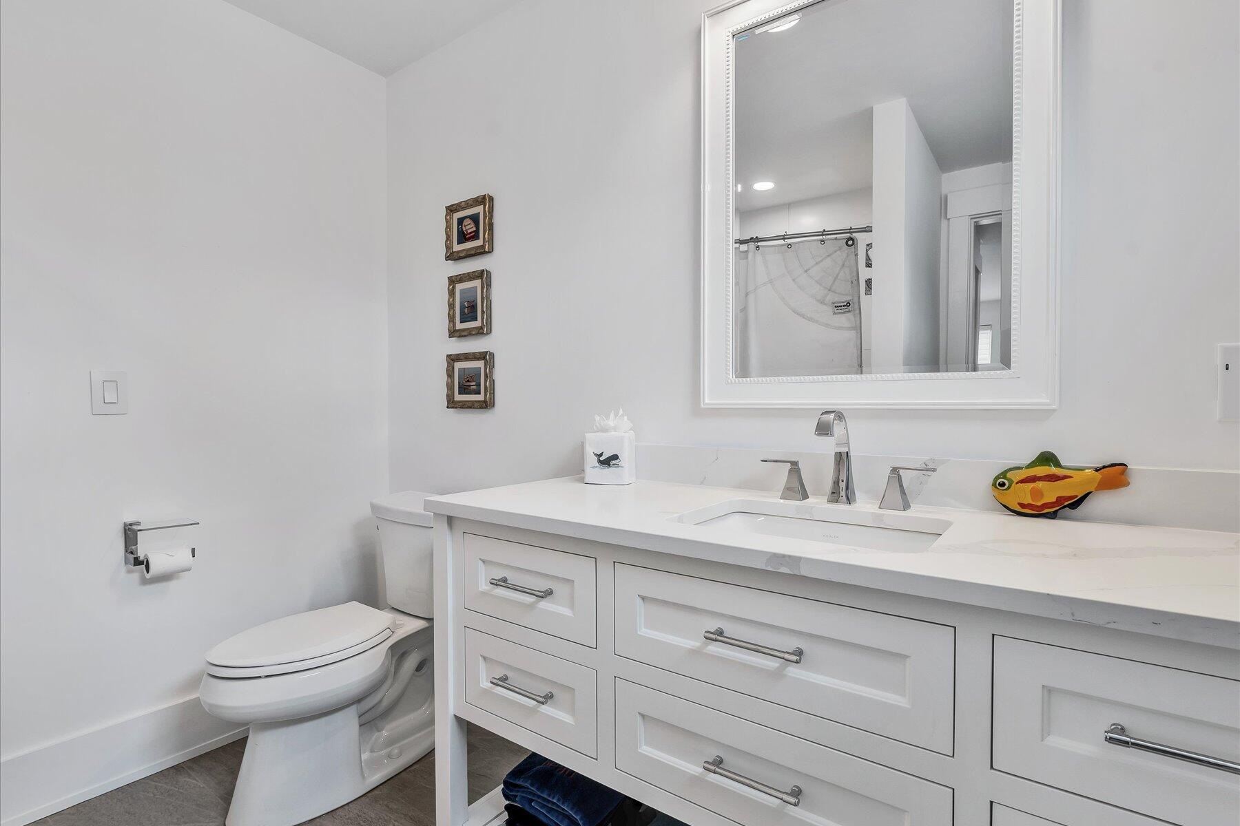 14 Willow Circle Mashpee, MA 02649 - Photo 48 of 60 a bathroom with a toilet a sink a vanity and mirror