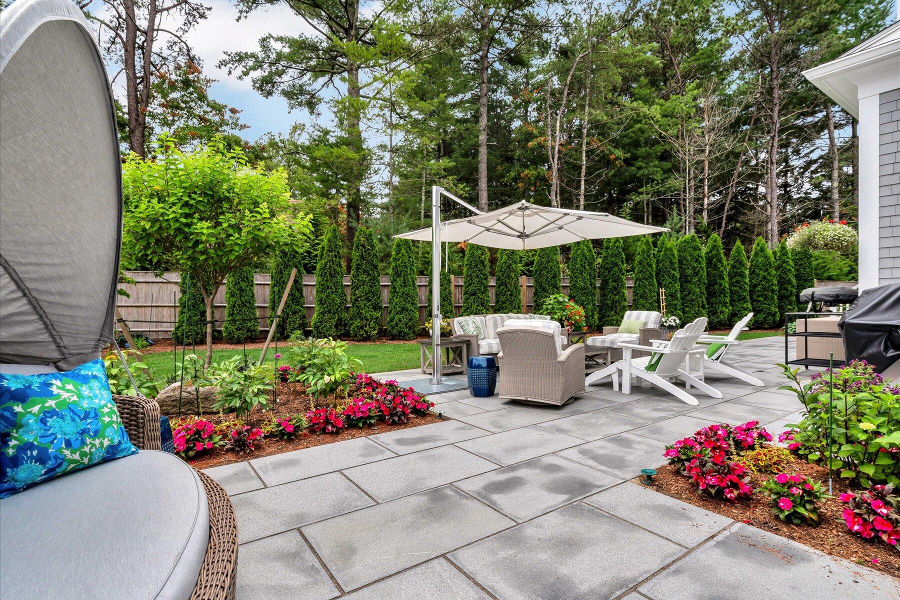 14 Willow Circle Mashpee, MA 02649 - Photo 9 of 60 a view of a patio with furniture and a garden