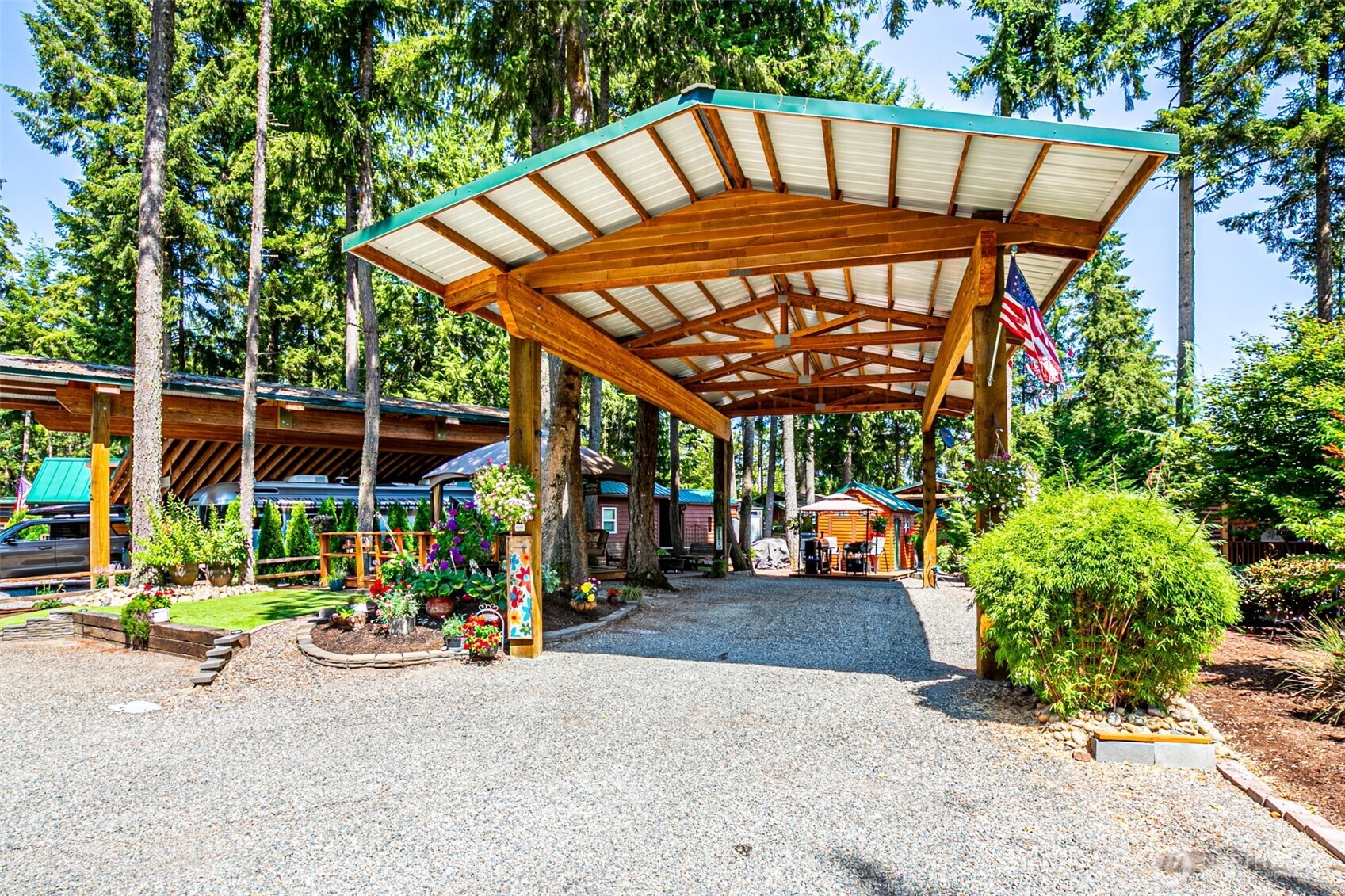 1546 Reservation Road Southeast, Unit 253 Olympia, WA 98513 - Photo 1 of 31 a view of the patio with a table and chairs under an umbrella