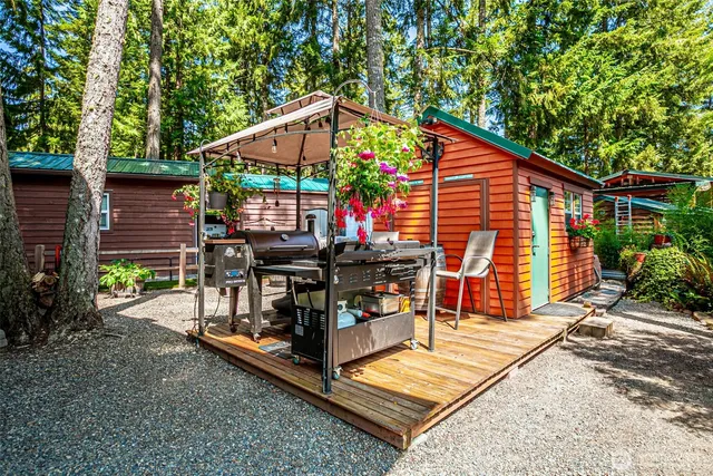a view of a backyard with sitting area and garden