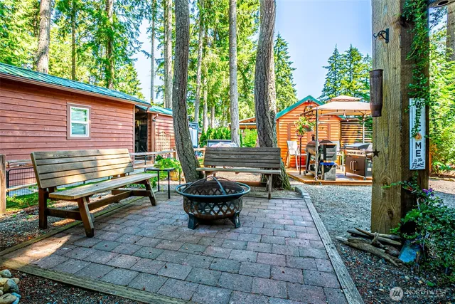 a view of a patio with chairs and flower plants