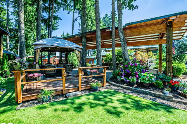a view of a chair and table in the back yard of the house