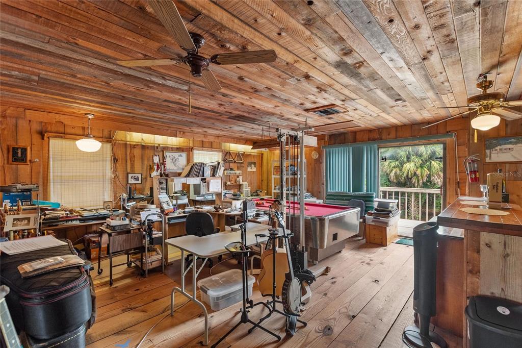 3641 Turtle Mound Road Melbourne, FL 32934 - Photo 44 of 77 a view of a dining room with furniture large windows and wooden floor