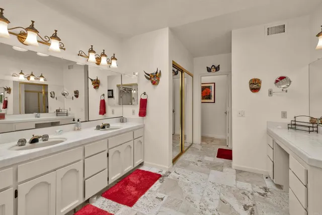 a bathroom with a tub sink and mirror