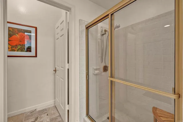 a bathroom with a painting on the wall and a shower