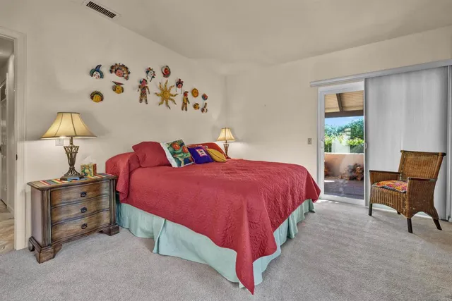 a bed room with a bed and a chair