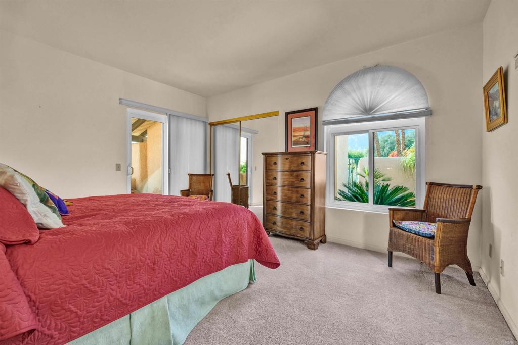202 Pointing Rock Drive, Unit 4 Borrego Springs, CA 92004 - Photo 15 of 27 a bedroom with a bed and a chair