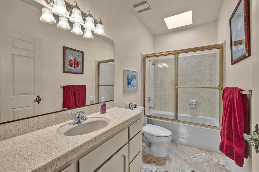 202 Pointing Rock Drive, Unit 4 Borrego Springs, CA 92004 - Photo 16 of 27 a bathroom with a granite countertop sink a toilet and shower