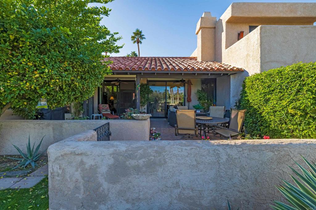 202 Pointing Rock Drive, Unit 4 Borrego Springs, CA 92004 - Photo 17 of 27 a view of a patio with table and chairs potted plants