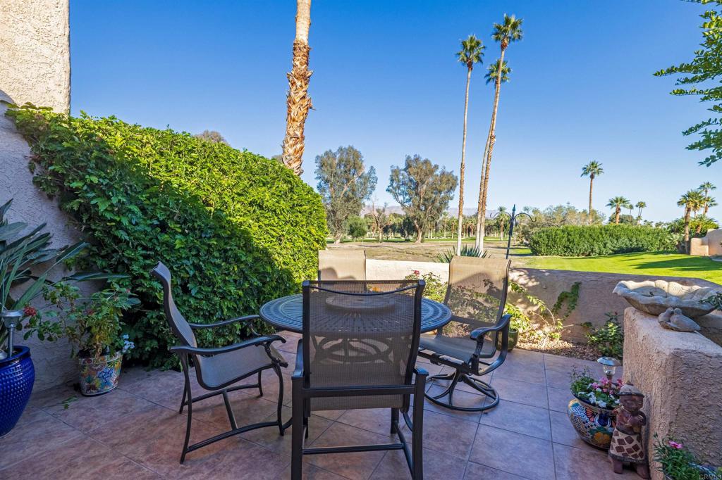 202 Pointing Rock Drive, Unit 4 Borrego Springs, CA 92004 - Photo 18 of 27 a view of a chairs and table in patio with a lake view