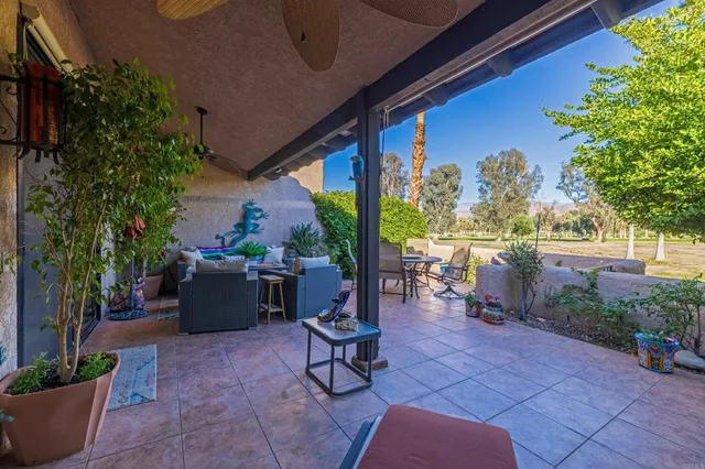 a building outdoor space with patio furniture and potted plants