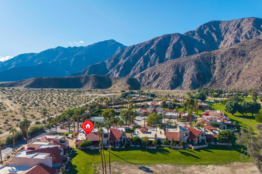 202 Pointing Rock Drive, Unit 4 Borrego Springs, CA 92004 - Photo 23 of 27 a view of a backyard with plants and a garden