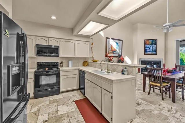 a kitchen with a sink cabinets and stainless steel appliances