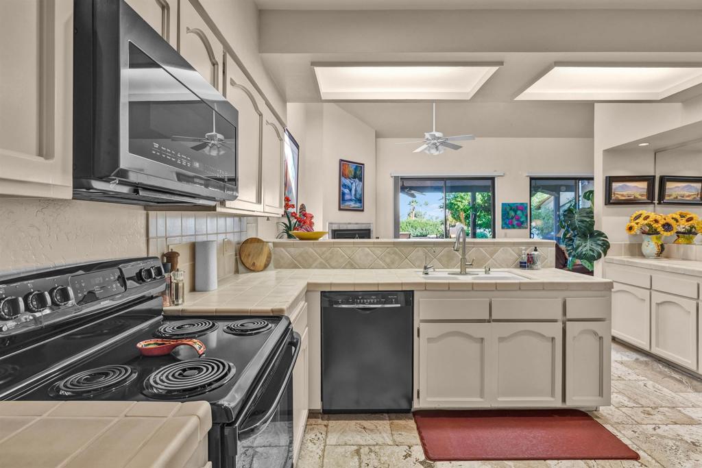 202 Pointing Rock Drive, Unit 4 Borrego Springs, CA 92004 - Photo 7 of 27 a kitchen with a stove and cabinets