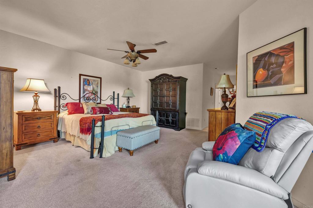 202 Pointing Rock Drive, Unit 4 Borrego Springs, CA 92004 - Photo 9 of 27 a bedroom with a bed a couch and dresser