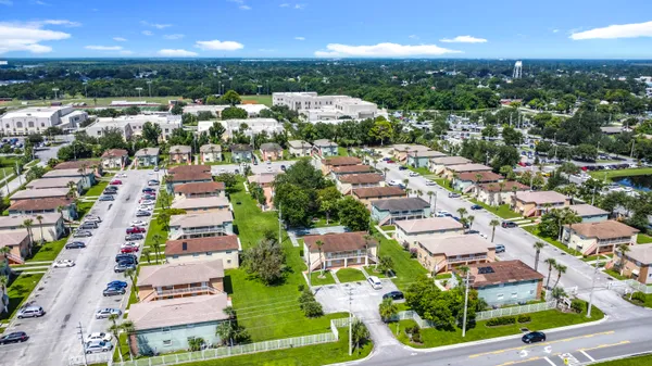 an aerial view of residential houses with outdoor space and lake view