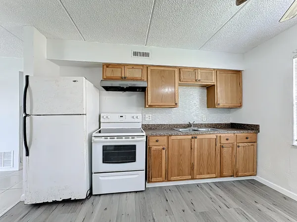 a kitchen with stainless steel appliances granite countertop a stove a refrigerator and a microwave
