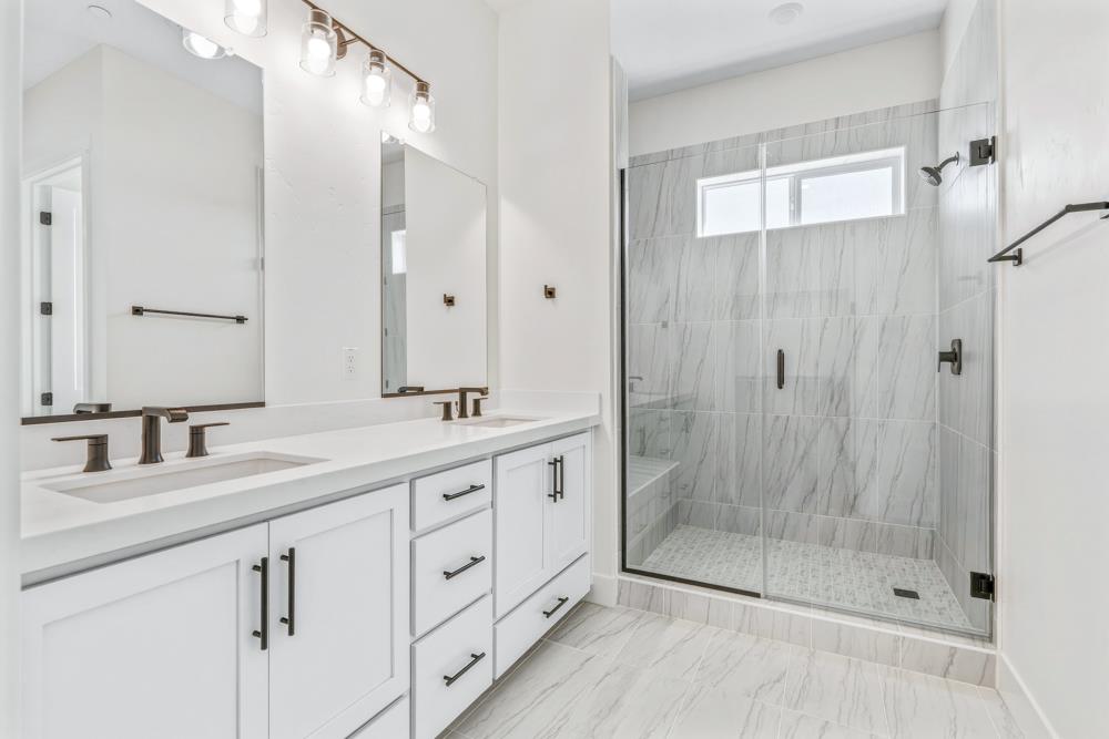 14834 Grace Warren Way Rancho Murieta, CA 95683 - Photo 18 of 21 a bathroom with double sink and a shower