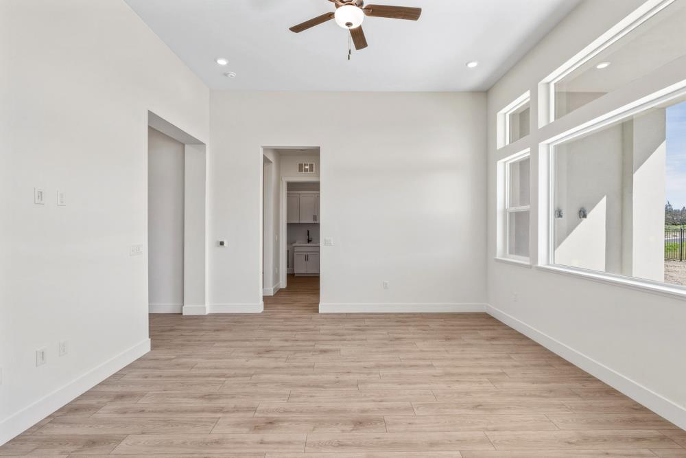 14834 Grace Warren Way Rancho Murieta, CA 95683 - Photo 5 of 21 wooden floor in an empty room with a window