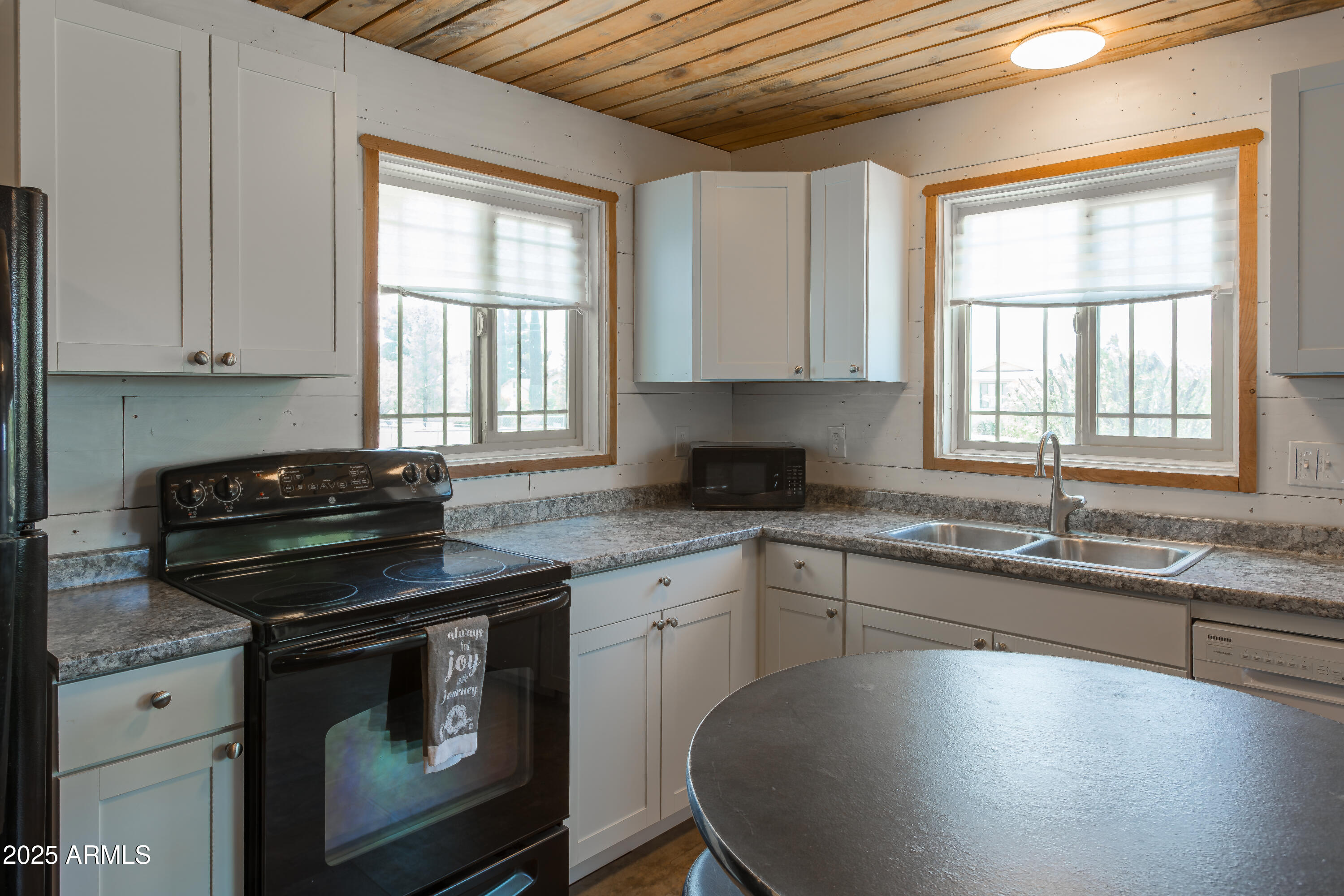 208 Hereford Road Bisbee, AZ 85603 - Photo 16 of 41 a kitchen with granite countertop a sink stove and cabinets