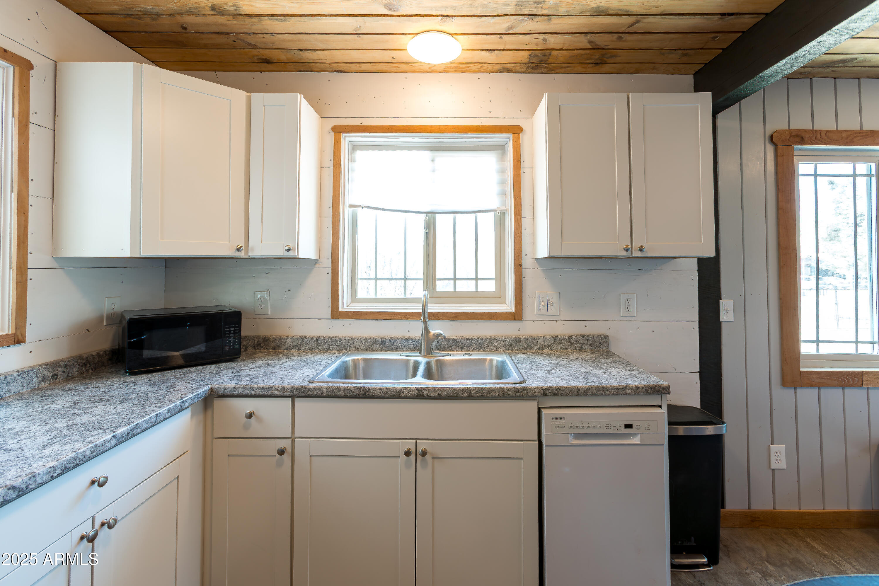 208 Hereford Road Bisbee, AZ 85603 - Photo 17 of 41 a kitchen with granite countertop white cabinets and a window
