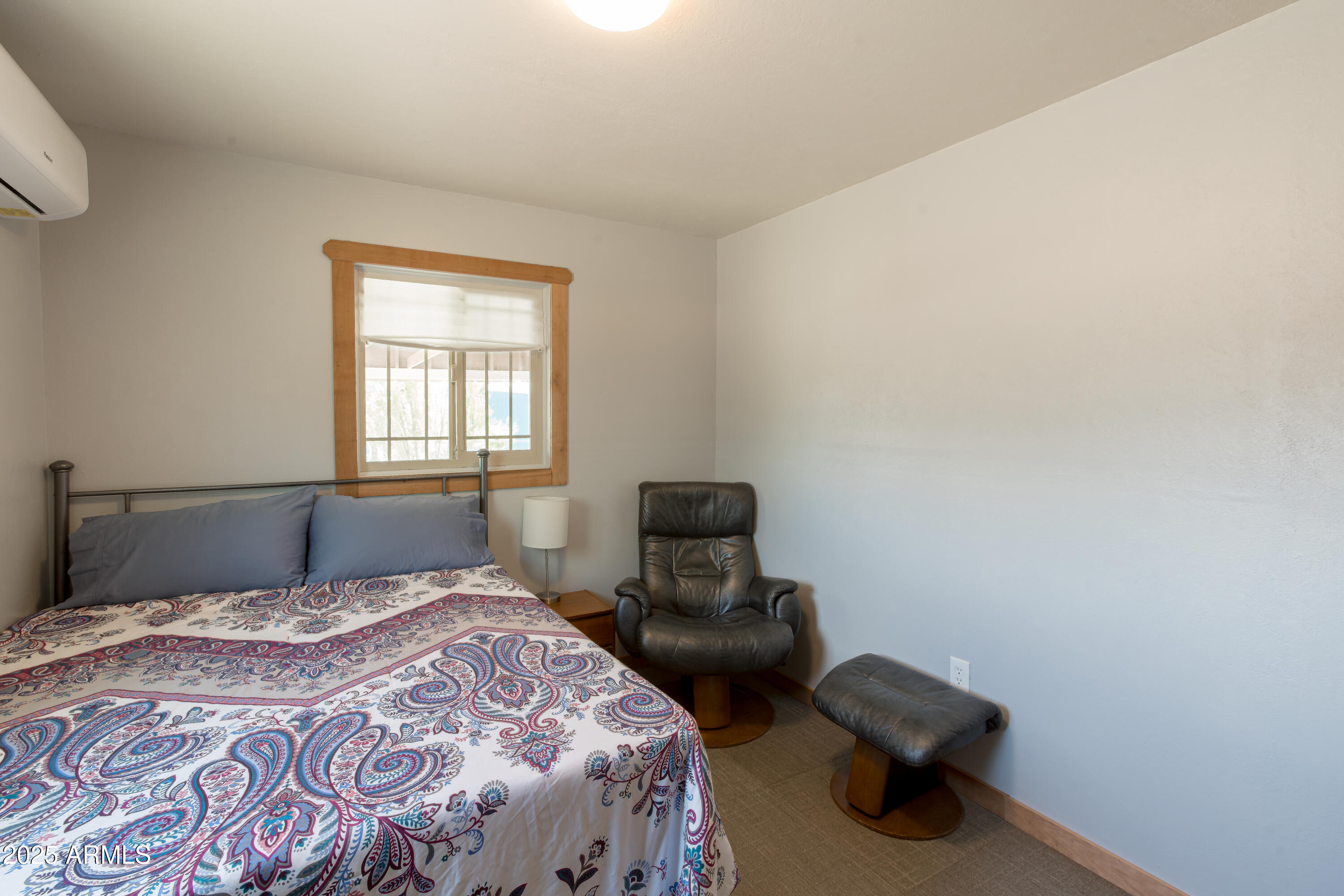 208 Hereford Road Bisbee, AZ 85603 - Photo 19 of 41 a bedroom with a bed and a chair