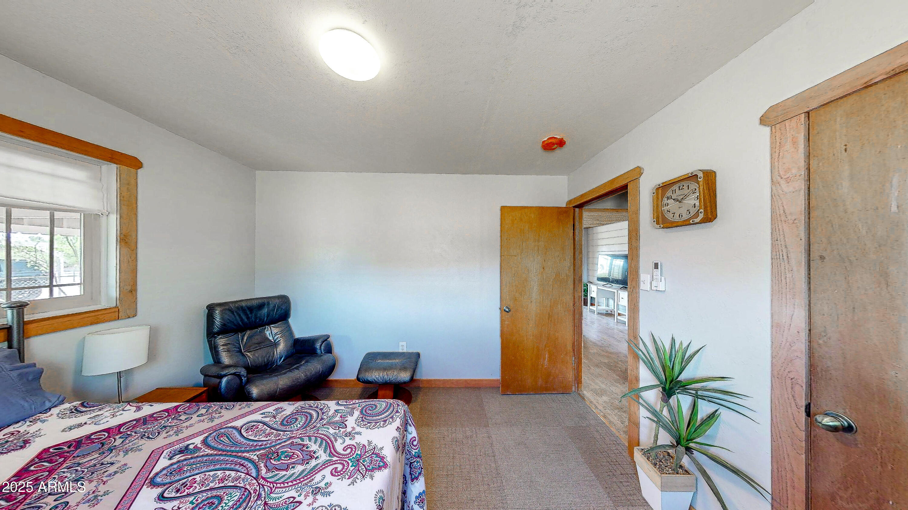 208 Hereford Road Bisbee, AZ 85603 - Photo 20 of 41 a bedroom with a bed and wooden floor