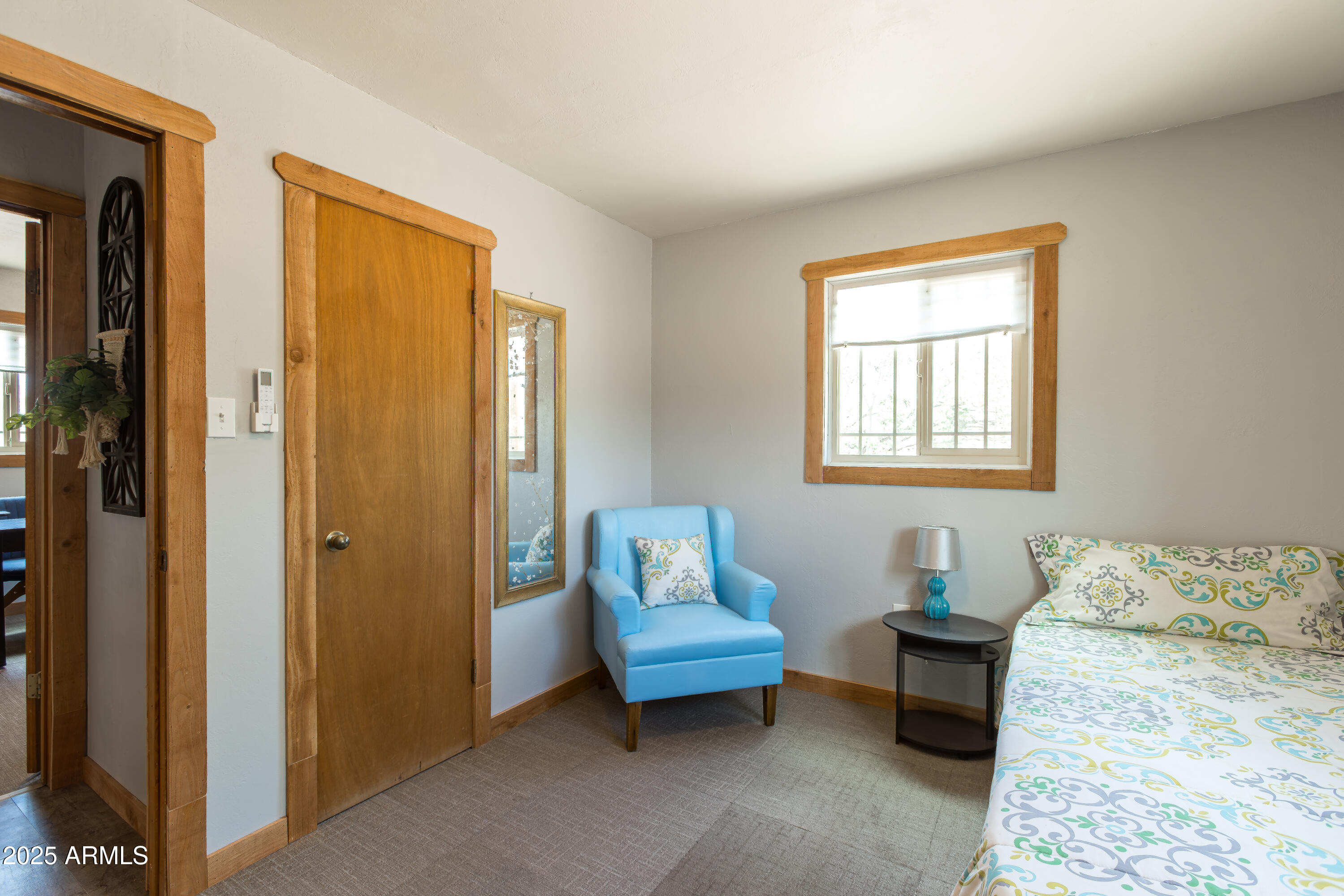 208 Hereford Road Bisbee, AZ 85603 - Photo 22 of 41 a bedroom with a bed and wooden floor