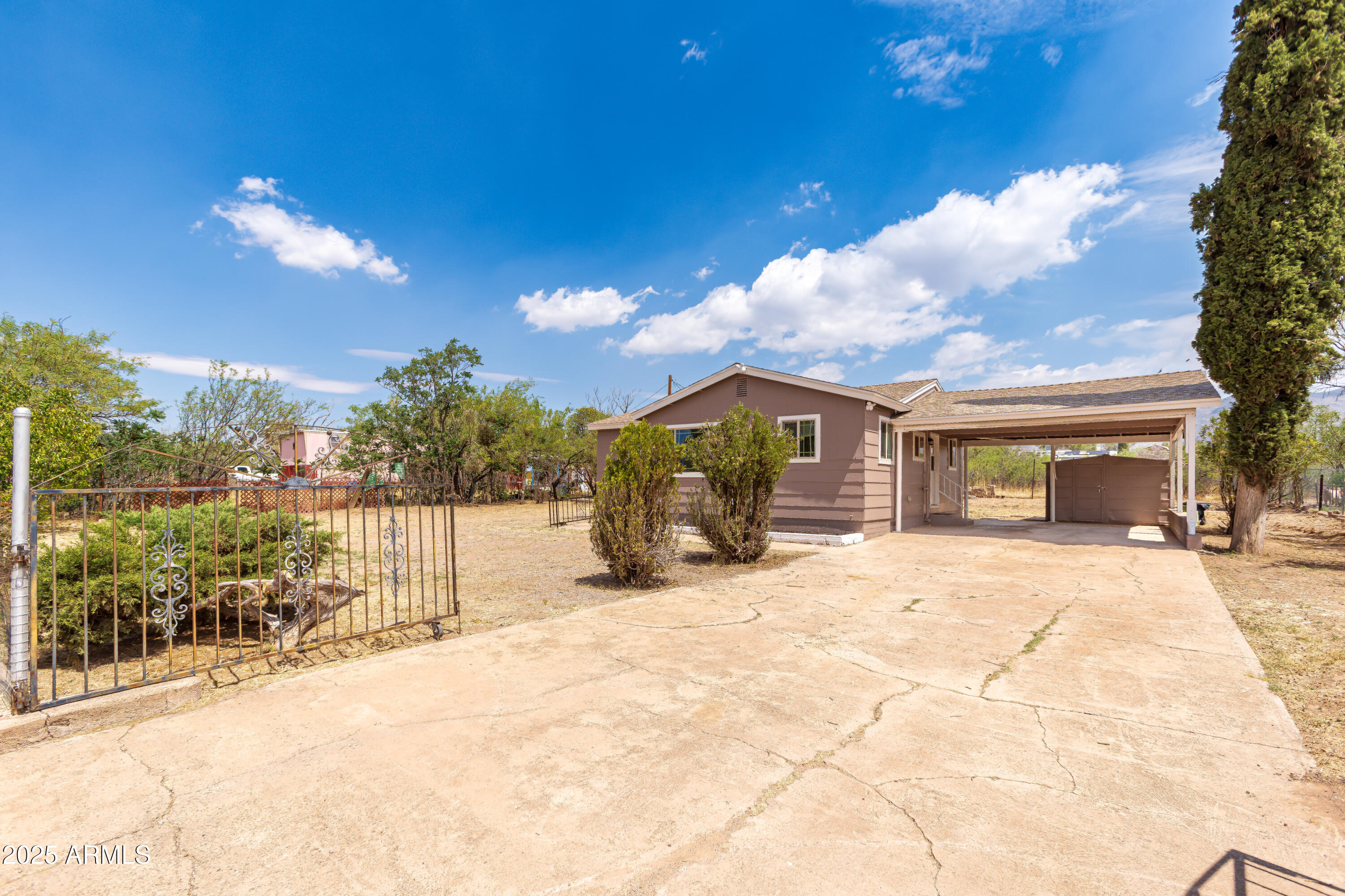 208 Hereford Road Bisbee, AZ 85603 - Photo 3 of 41 a view of a house with wooden fence