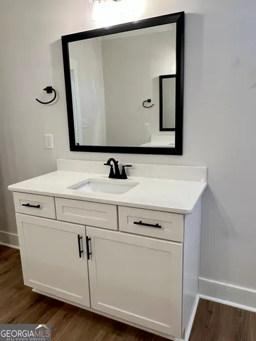 a view of a room with wooden floor and a ceiling fan