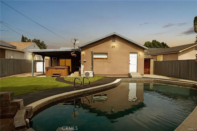 a view of a house with backyard and sitting area