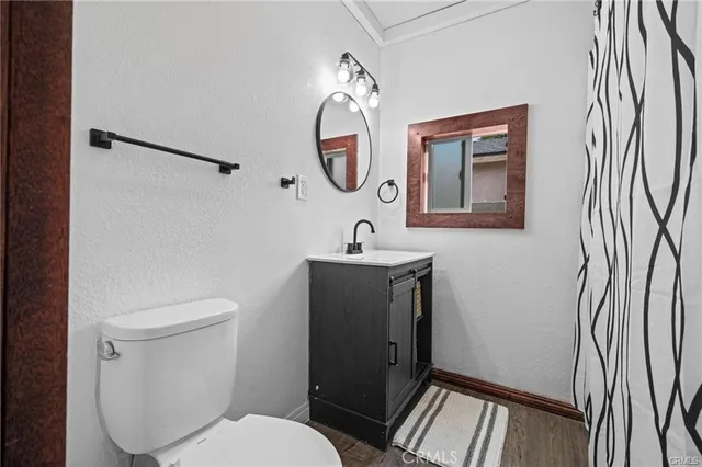 a bathroom with a toilet a sink and a mirror