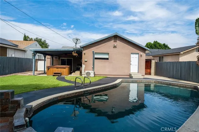 a backyard of a house with table and chairs a barbeque with wooden fence