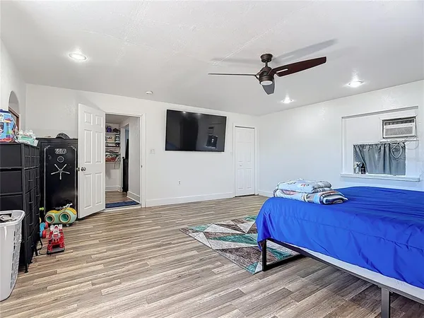 a bedroom with a bed and a flat screen tv