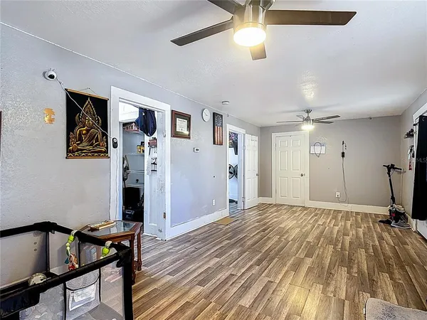 a living room with furniture a flat screen tv and a window