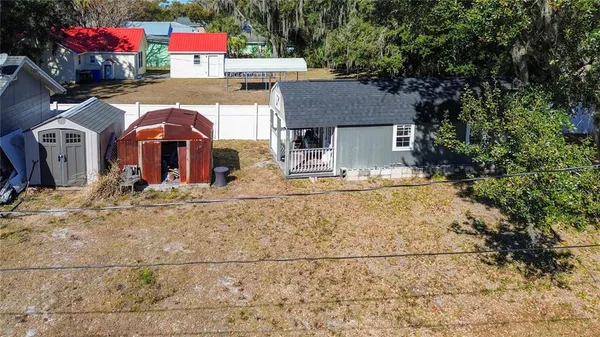 a view of a house with a yard covered in snow