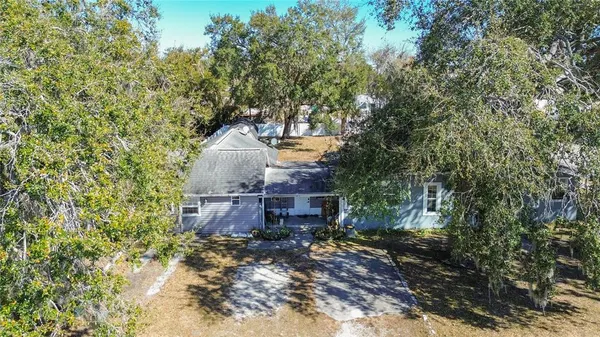 an aerial view of multiple houses with yard