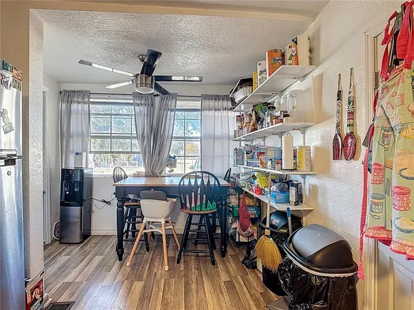 a dining room with furniture and wooden floor