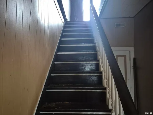 a view of a hallway to room with furniture