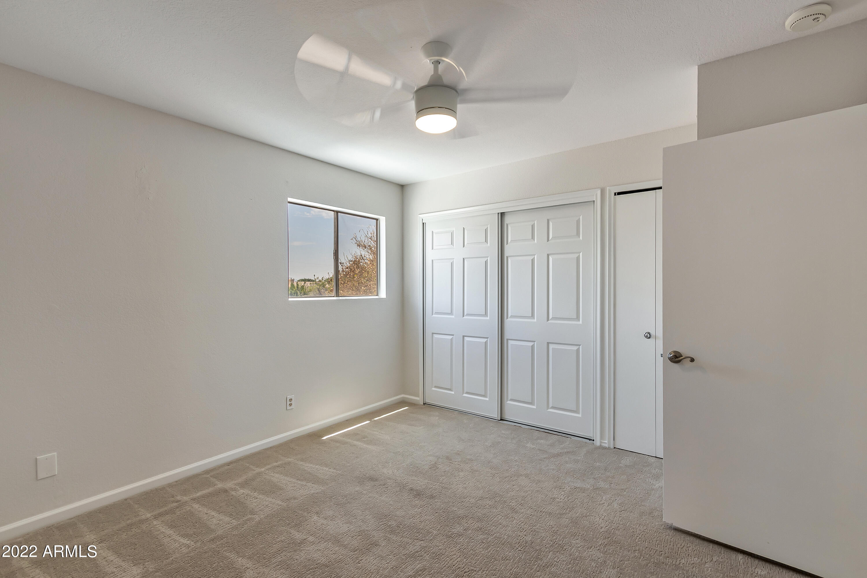 6348 North 7th Avenue, Unit 12 Phoenix, AZ 85013 - Photo 15 of 22 a view of an empty room with a ceiling fan