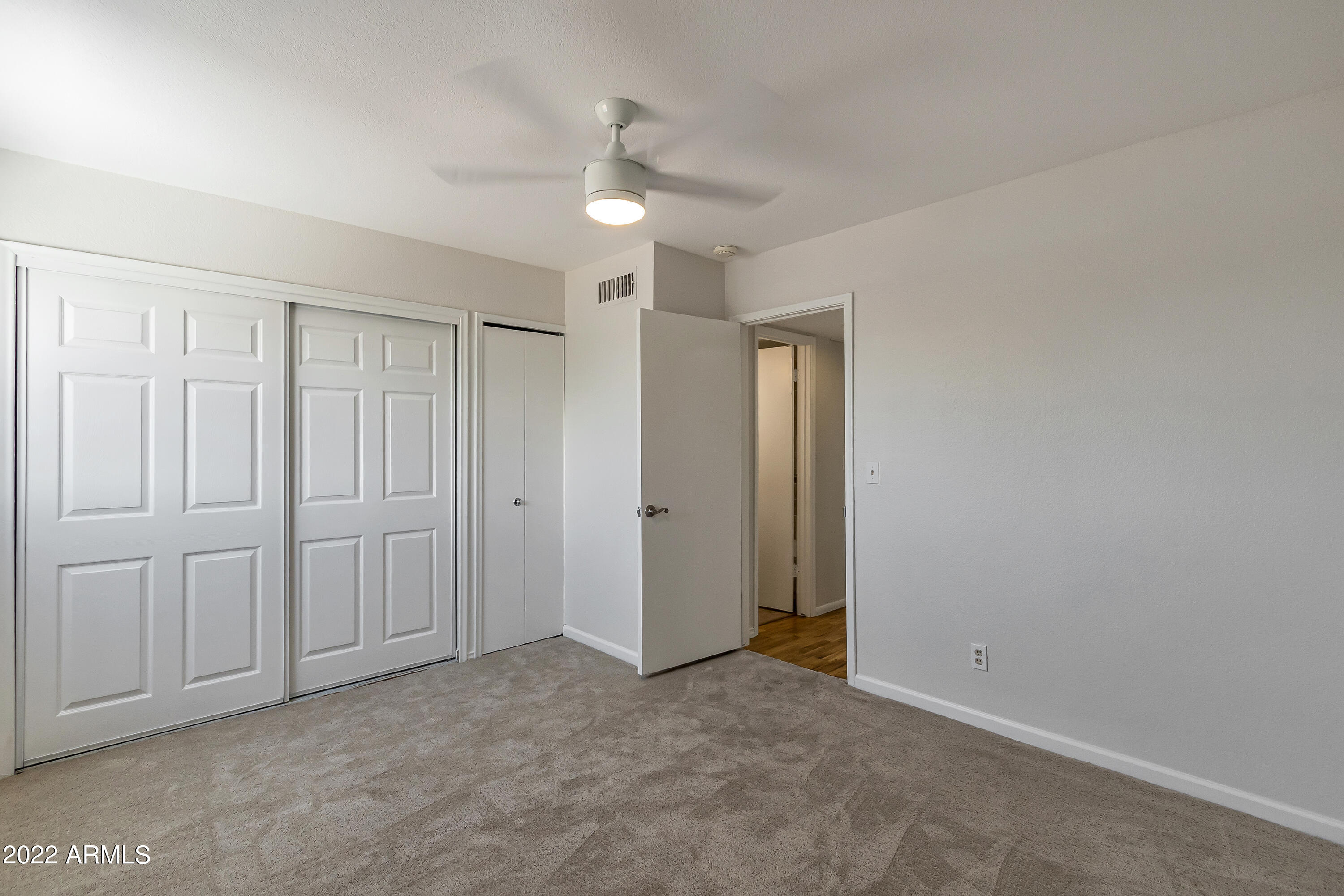 6348 North 7th Avenue, Unit 12 Phoenix, AZ 85013 - Photo 16 of 22 a view of an empty room and chandelier fan