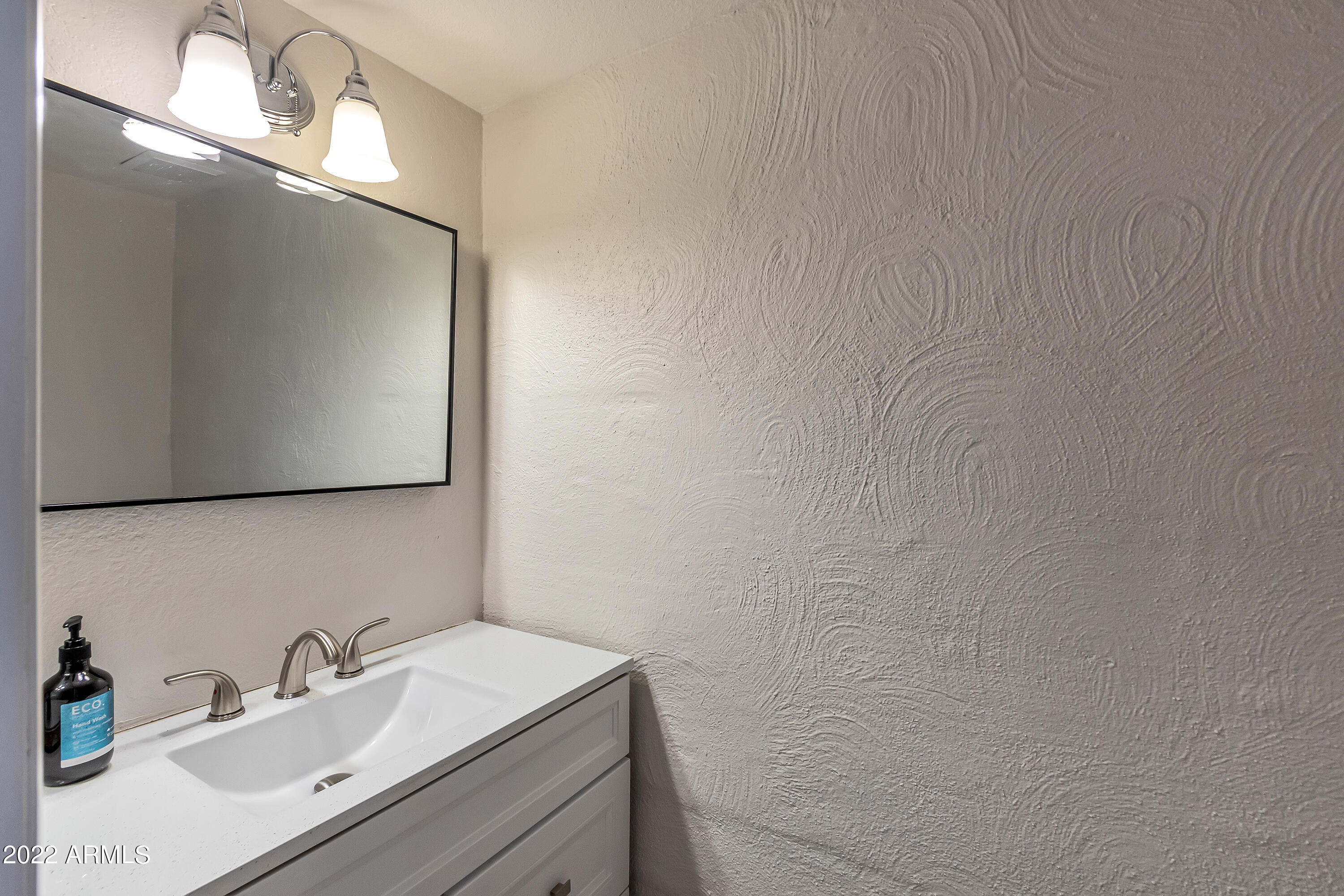 6348 North 7th Avenue, Unit 12 Phoenix, AZ 85013 - Photo 17 of 22 a bathroom with a sink and a mirror