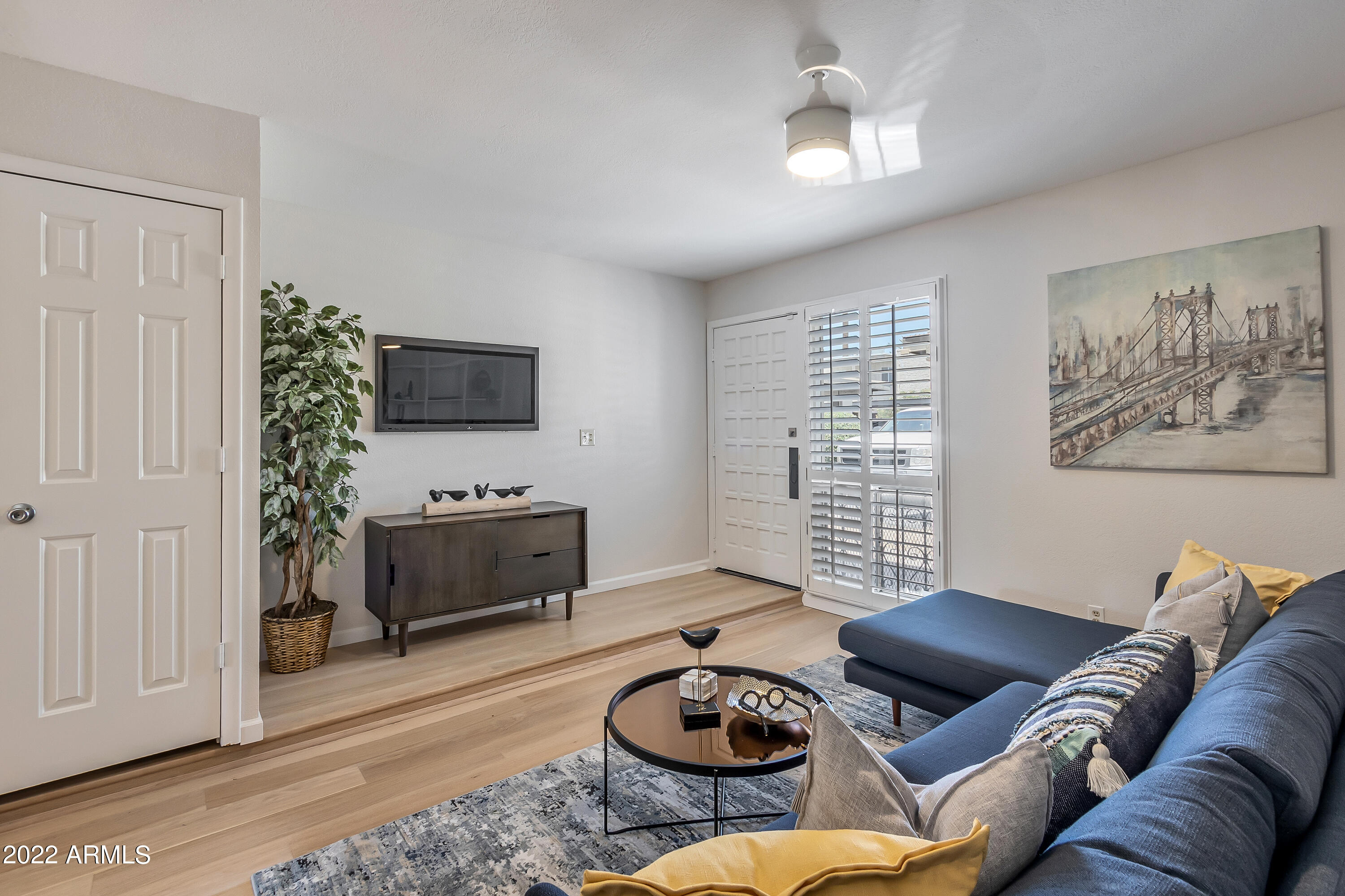 6348 North 7th Avenue, Unit 12 Phoenix, AZ 85013 - Photo 3 of 22 a living room with furniture and a flat screen tv