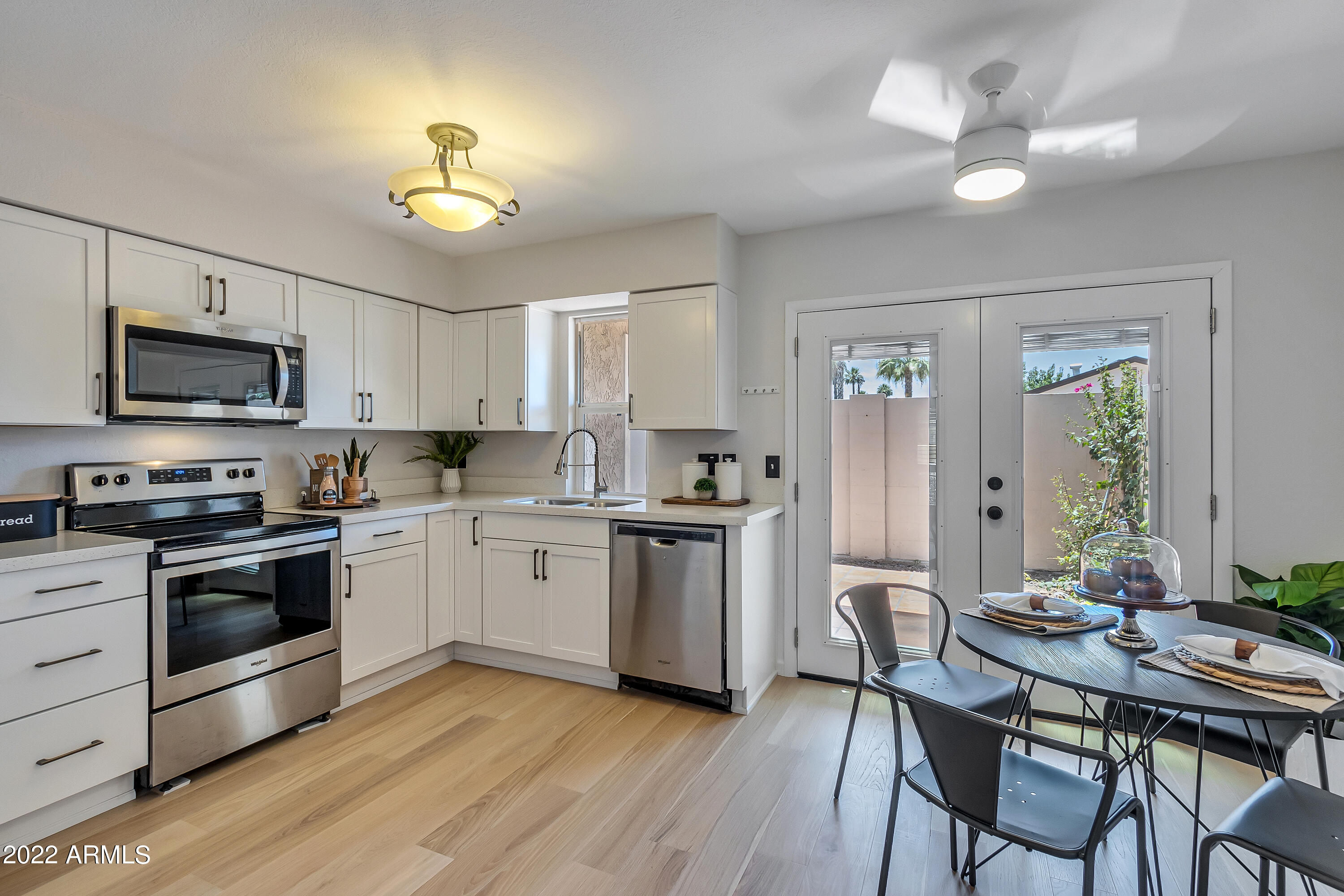 6348 North 7th Avenue, Unit 12 Phoenix, AZ 85013 - Photo 5 of 22 a kitchen with a table chairs refrigerator and cabinets