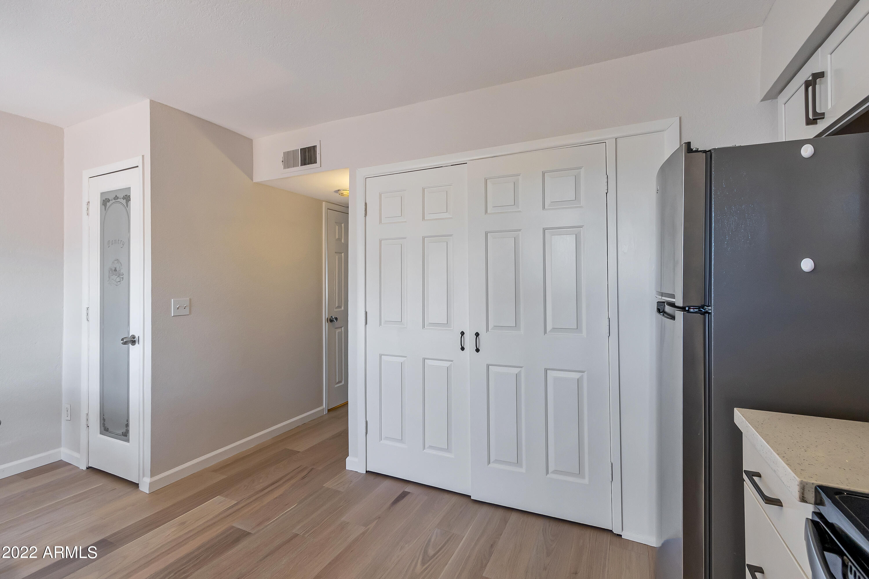 6348 North 7th Avenue, Unit 12 Phoenix, AZ 85013 - Photo 8 of 22 a view of empty room with wooden floor